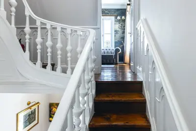 a white staircase with white railings and wood floors at Victoria Mansion A Luxurious Neoclassical Experience in Rhodes Town