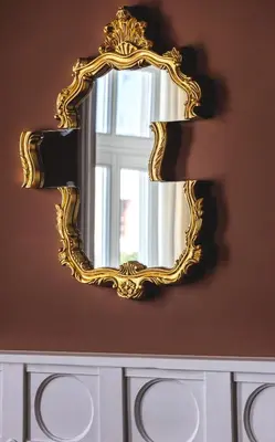 a gold mirror on a wall next to a window at Victoria Mansion A Luxurious Neoclassical Experience in Rhodes Town