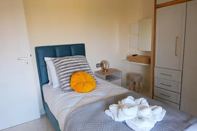 a bedroom with a bed with towels on it at Hillside Horizon Villa in Rhodes Town