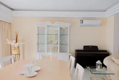 a dining room with a table and a piano at Hillside Horizon Villa in Rhodes Town