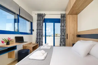 a bedroom with a bed and a desk and a window at Villa Mariani II - in Lothiarika, newly renovated June 2024, private pool, Lindos 10 min, beach 120m in Lardos