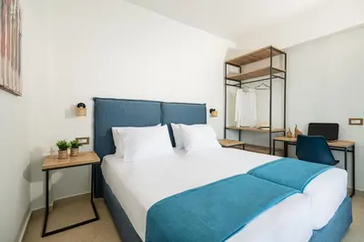 a bedroom with a large bed with a blue headboard at Villa Mariani II - in Lothiarika, newly renovated June 2024, private pool, Lindos 10 min, beach 120m in Lardos