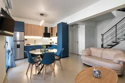 a living room and kitchen with a couch and a table at Villa Mariani II - in Lothiarika, newly renovated June 2024, private pool, Lindos 10 min, beach 120m in Lardos