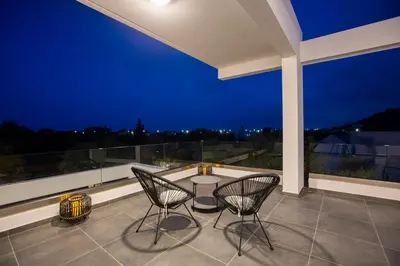 a patio with a table and chairs on a balcony at Villa Laura in Afantou