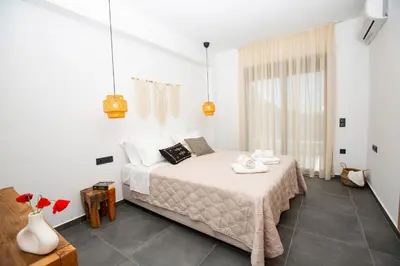 a bedroom with a bed in a white room at Villa Laura in Afantou