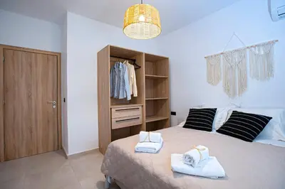 a bedroom with a bed with towels on it at Villa Laura in Afantou