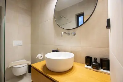 a bathroom with a white sink and a mirror at Villa Laura in Afantou