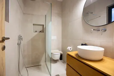 a bathroom with a sink and a glass shower at Villa Laura in Afantou