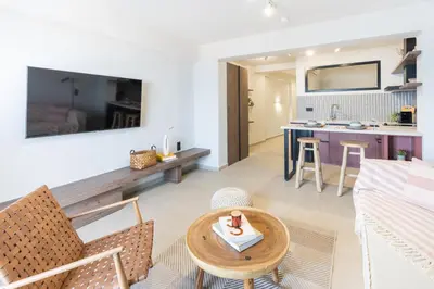 a living room with a couch and a table at Sunny Sands Seaview Apartment in Archangelos