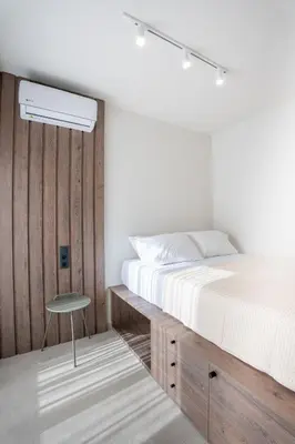 a bedroom with a bed and a table next to it at Sunny Sands Seaview Apartment in Archangelos