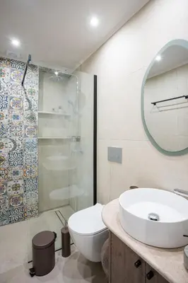 a bathroom with a sink and a toilet and a shower at Sunny Sands Seaview Apartment in Archangelos