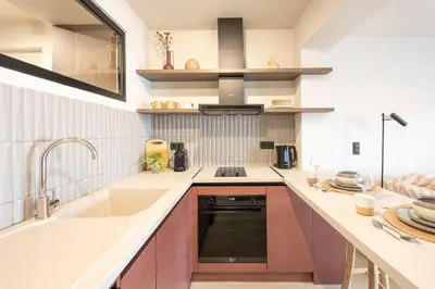 a kitchen with pink cabinets and a sink at Sunny Sands Seaview Apartment in Archangelos