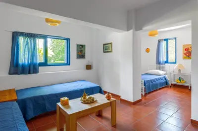 a living room with a bed and a table at Villa Costa Haraki in Haraki