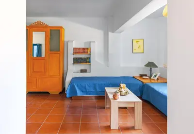 a room with a bed and a table in a room at Villa Costa Haraki in Haraki