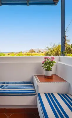 a balcony with a table and a potted plant at Villa Costa Haraki in Haraki