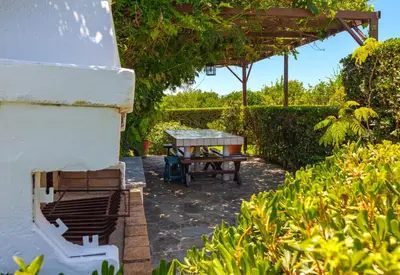 a patio with a table and a picnic table at Villa Costa Haraki in Haraki