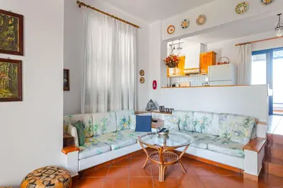 a living room with a couch and a table at Villa Costa Haraki in Haraki