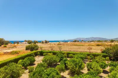 a garden in the middle of a field at Villa Costa Haraki in Haraki
