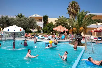 a group of people in the swimming pool at a resort at Golden Odyssey in Kolimbia