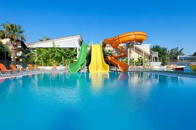 a pool with a water slide in a resort at Golden Odyssey in Kolimbia