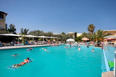 a group of people swimming in a swimming pool at Golden Odyssey in Kolimbia