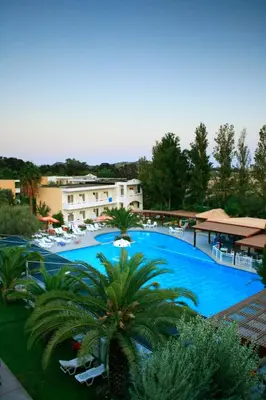 a view of a large swimming pool with chairs and trees at Golden Odyssey in Kolimbia