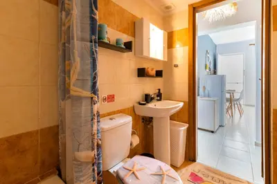 a bathroom with a toilet and a sink at Lilliput Garden in Rhodes Town