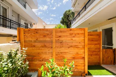 a wooden fence in front of a house at Lilliput Garden in Rhodes Town