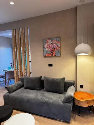 a living room with a couch and a table at City Compass Luxury Suites Faliraki in Faliraki