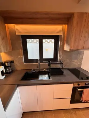 a kitchen with a sink and a window at City Compass Luxury Suites Faliraki in Faliraki