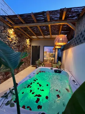 a jacuzzi tub in the middle of a room at City Compass Luxury Suites Faliraki in Faliraki
