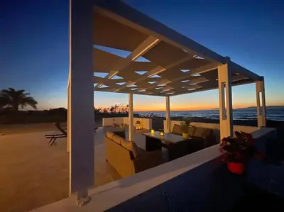 a view of a patio with a view of the ocean at Lambou Beach Sunset in Soroni