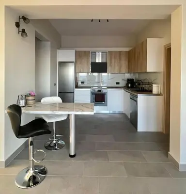 a large kitchen with a table and chairs in it at Lambou Beach Sunset in Soroni