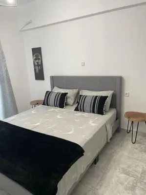 a bed with two pillows on it in a bedroom at BeeHouse in Kalithies