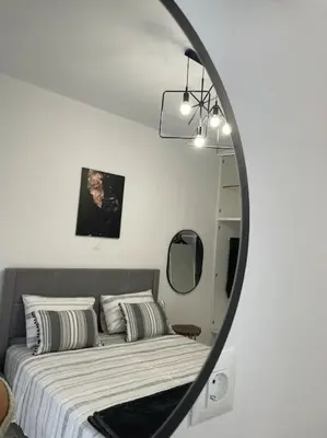 a bedroom with a bed and a mirror at BeeHouse in Kalithies