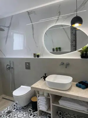 a bathroom with a sink and a toilet and a mirror at BeeHouse in Kalithies