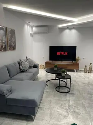 a living room with a couch and a tv at BeeHouse in Kalithies
