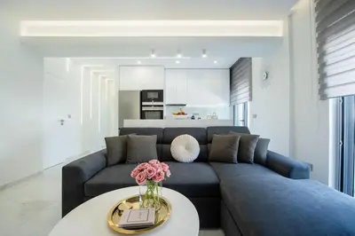 a living room with a blue couch and a table at Rhodes Center Luxury Suite in Rhodes Town