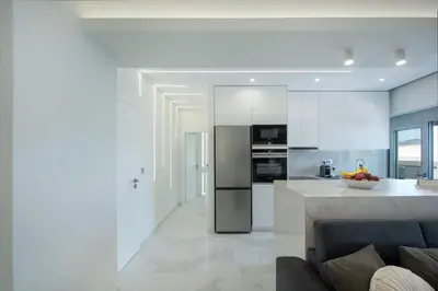 a kitchen and living room with a couch and a counter at Rhodes Center Luxury Suite in Rhodes Town