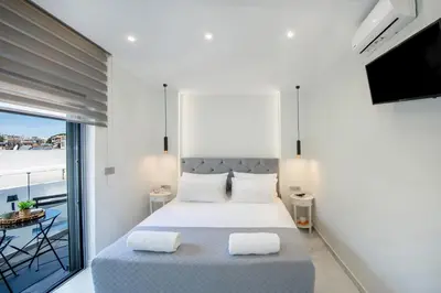 a bedroom with a bed and a balcony at Rhodes Center Luxury Suite in Rhodes Town