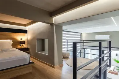 a bedroom with a bed and a balcony at Chrysma Urban Living in Rhodes Town
