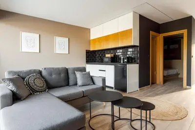 a living room with a couch and a table at Chrysma Urban Living in Rhodes Town
