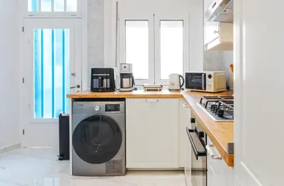 a kitchen with a washing machine on a counter at Themis' Urban Residence in Rhodes Town
