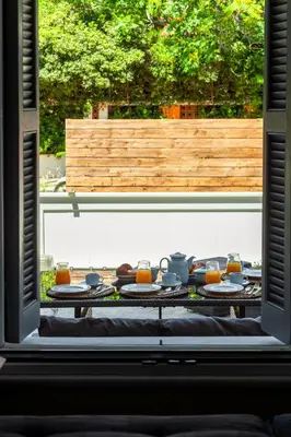a table with plates of food and orange juice at Themis' Urban Residence in Rhodes Town