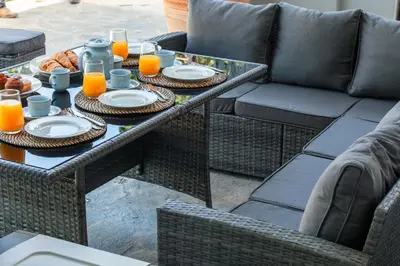 a table with plates of food and glasses of orange juice at Themis' Urban Residence in Rhodes Town