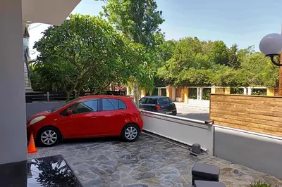 a small red car is parked on a balcony at Themis' Urban Residence in Rhodes Town