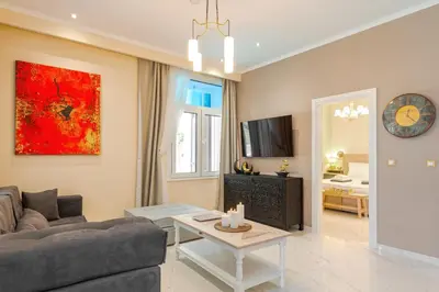a living room with a couch and a table at Themis' Urban Residence in Rhodes Town