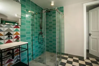 a bathroom with a shower with green tiles at Villa Luna Piena in Pefki Rhodes