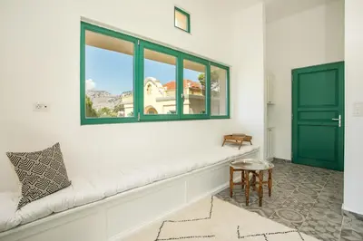 a white room with a bench and a window at Villa Luna Piena in Pefki Rhodes