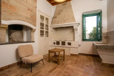 a kitchen with a table and a chair and a sink at Villa Luna Piena in Pefki Rhodes